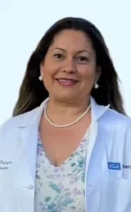 Sonrisa Family Dental dentist in white coat with pearl necklace smiling