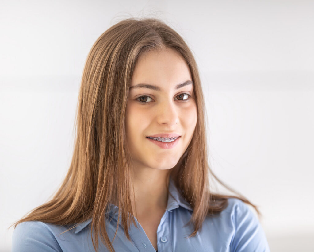 Portrait of happy smiling girl with dental braces.